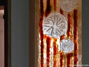 Amber coloured fused art glass wall with the floral motif