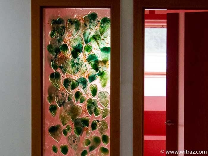 Art glass partitions by the door with the green leafs motif