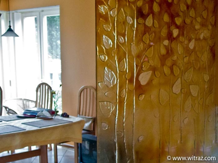 Autumnal leaves decorated glass wall, artistic adornment of the stairway.