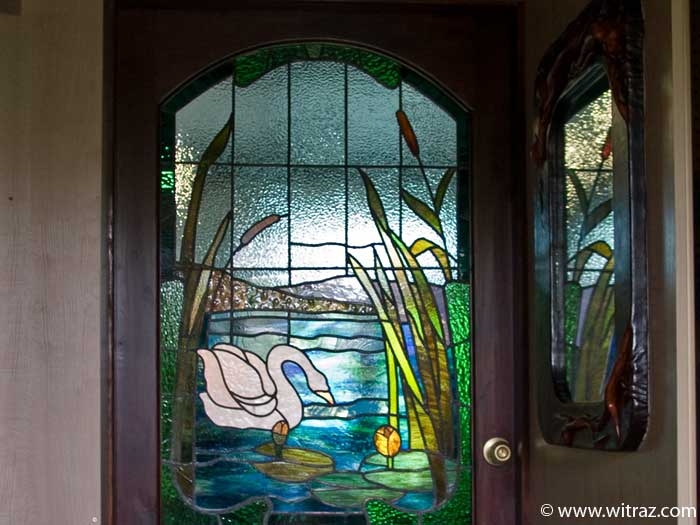 Art glazing of the door with the swan motif