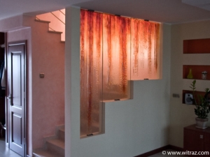 Textured gold coloured art glass wall - covers the stairs