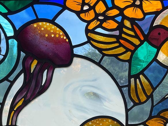 Stained glass with hummingbirds and jellyfishes