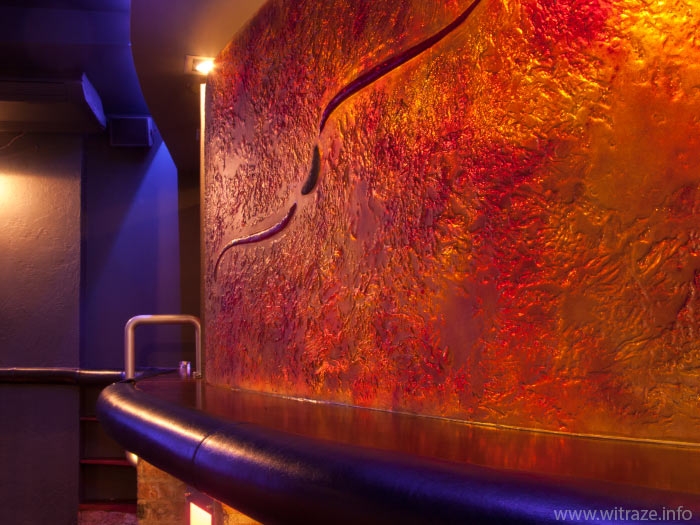 Curved colored glass panel in a night club